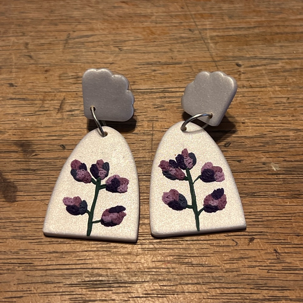 White earring with purple. Flowers